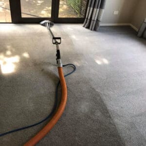 Residential carpet cleaning in progress in a living room.