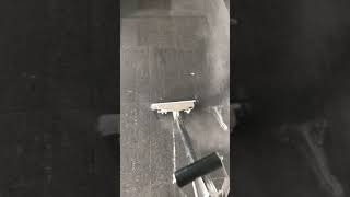Steam cleaning hard floors using specialized equipment.