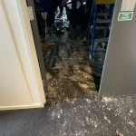 Triple Star Commercial Cleaning team performing flood cleanup in a water-damaged commercial building in Christchurch.