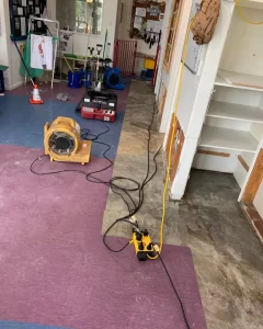 Flood drying equipment including air movers and dehumidifiers set up in a commercial space in Christchurch