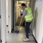 Office hallway floor being mopped by cleaning staff