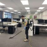 Triple Star Commercial Cleaning staff using a commercial-grade vacuum cleaner to deep clean office carpets in Auckland and Christchurch.