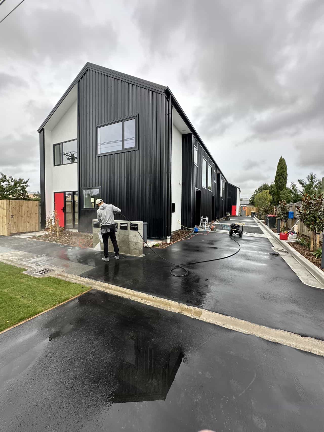 Post-construction cleaning of a driveway and exterior of a townhouse in Christchurch and Auckland.