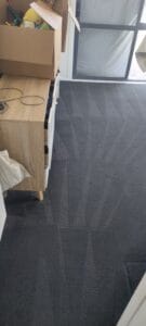 Dark grey carpet in a room after being professionally steam cleaned