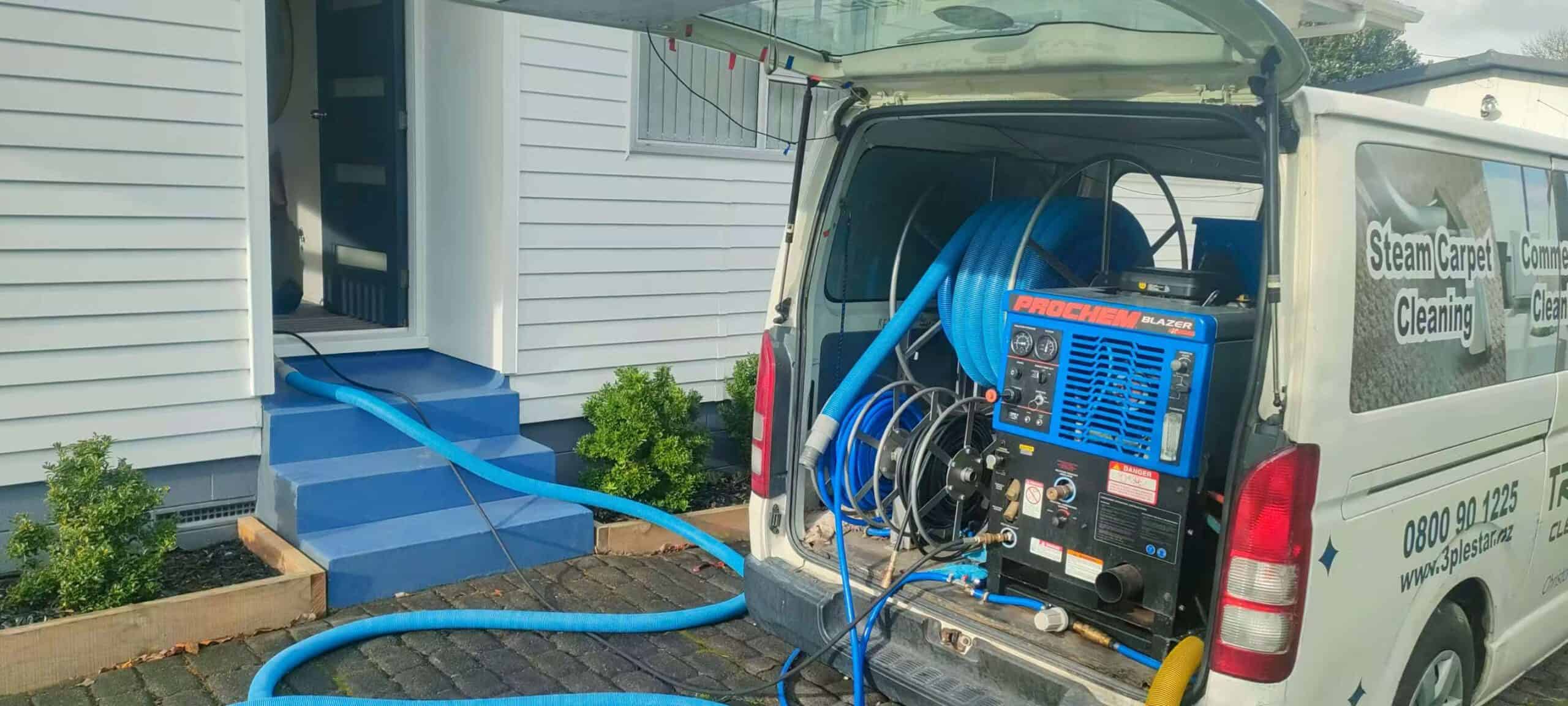Triple Star cleaning van with Prochem machine and hoses running into home