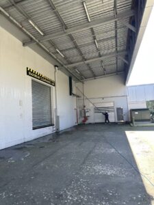 Commercial building exterior pressure washing in Christchurch using professional telescopic cleaning equipment by Triple Star Commercial Cleaning.