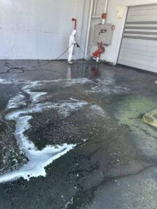 Commercial pressure washing of a loading dock and service area in Christchurch by Triple Star Commercial Cleaning.