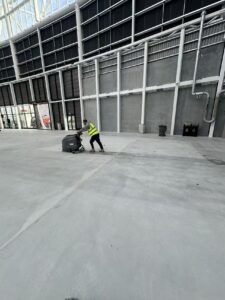 Builders cleaning floor scrubbing at One New Zealand Stadium in Christchurch by Triple Star Commercial Cleaning.