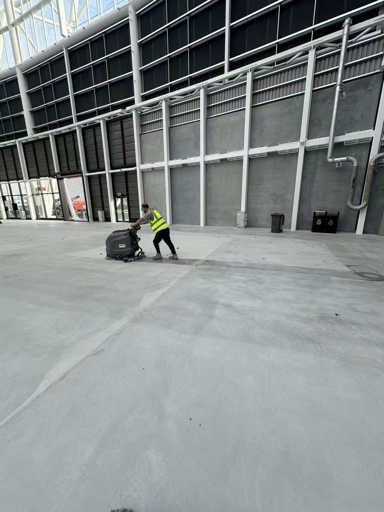Builders cleaning floor scrubbing at One New Zealand Stadium in Christchurch by Triple Star Commercial Cleaning.